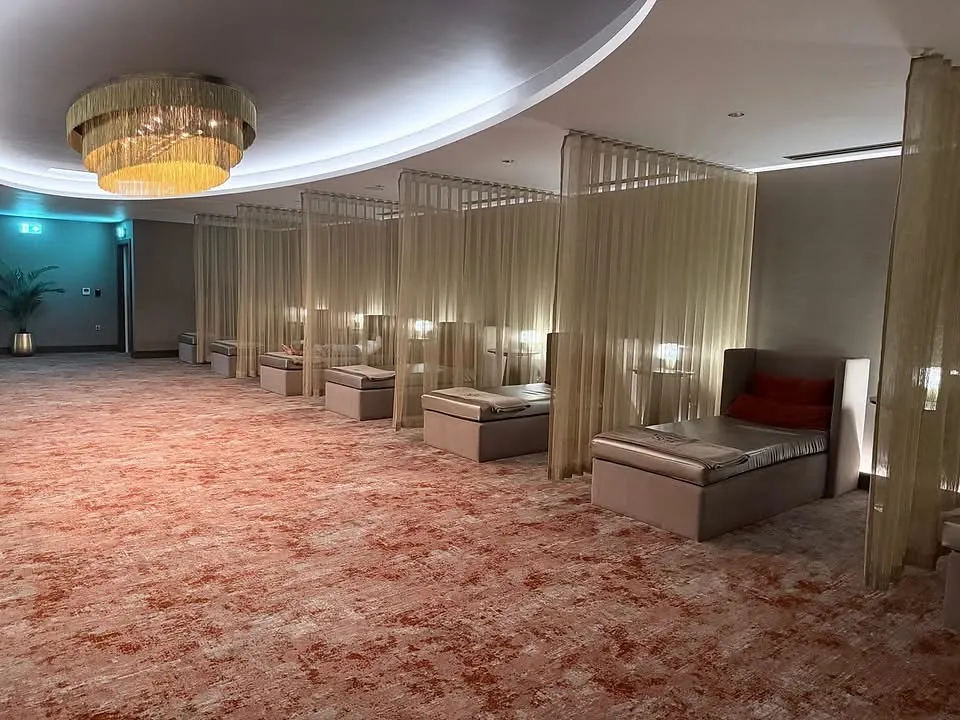 Relaxation room, curtained loungers and feature chandelier