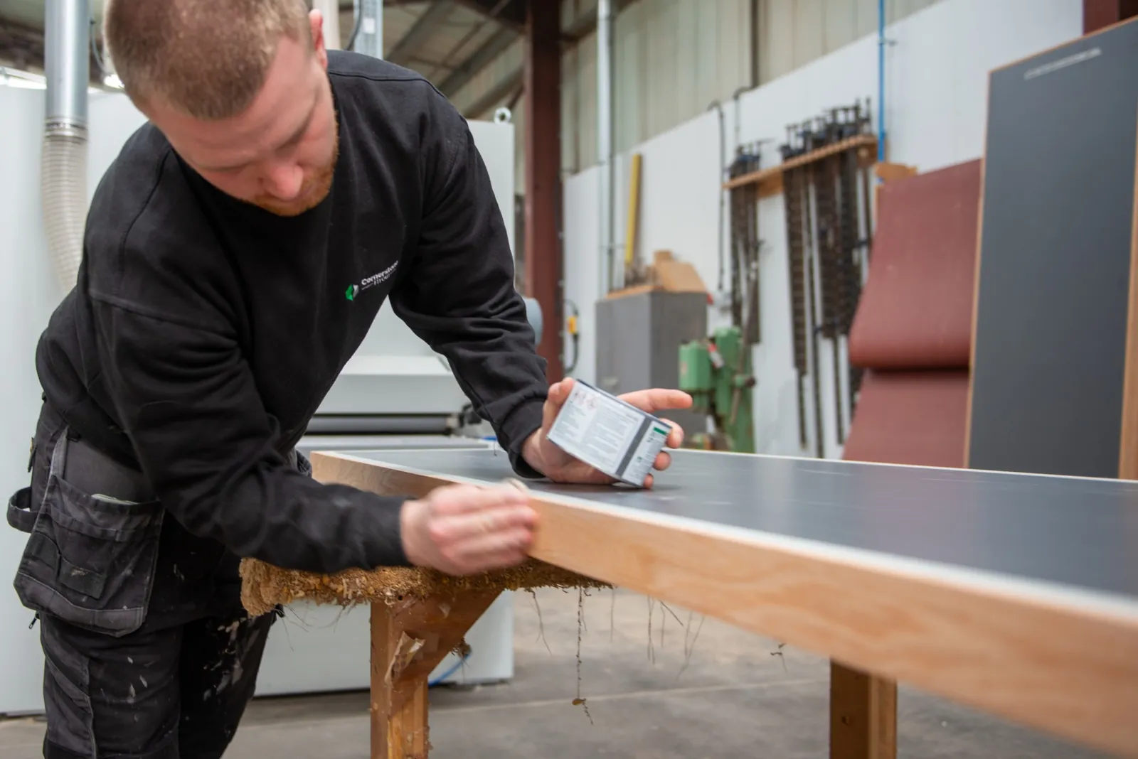 Hand-finishing the timber edge of a worktop
