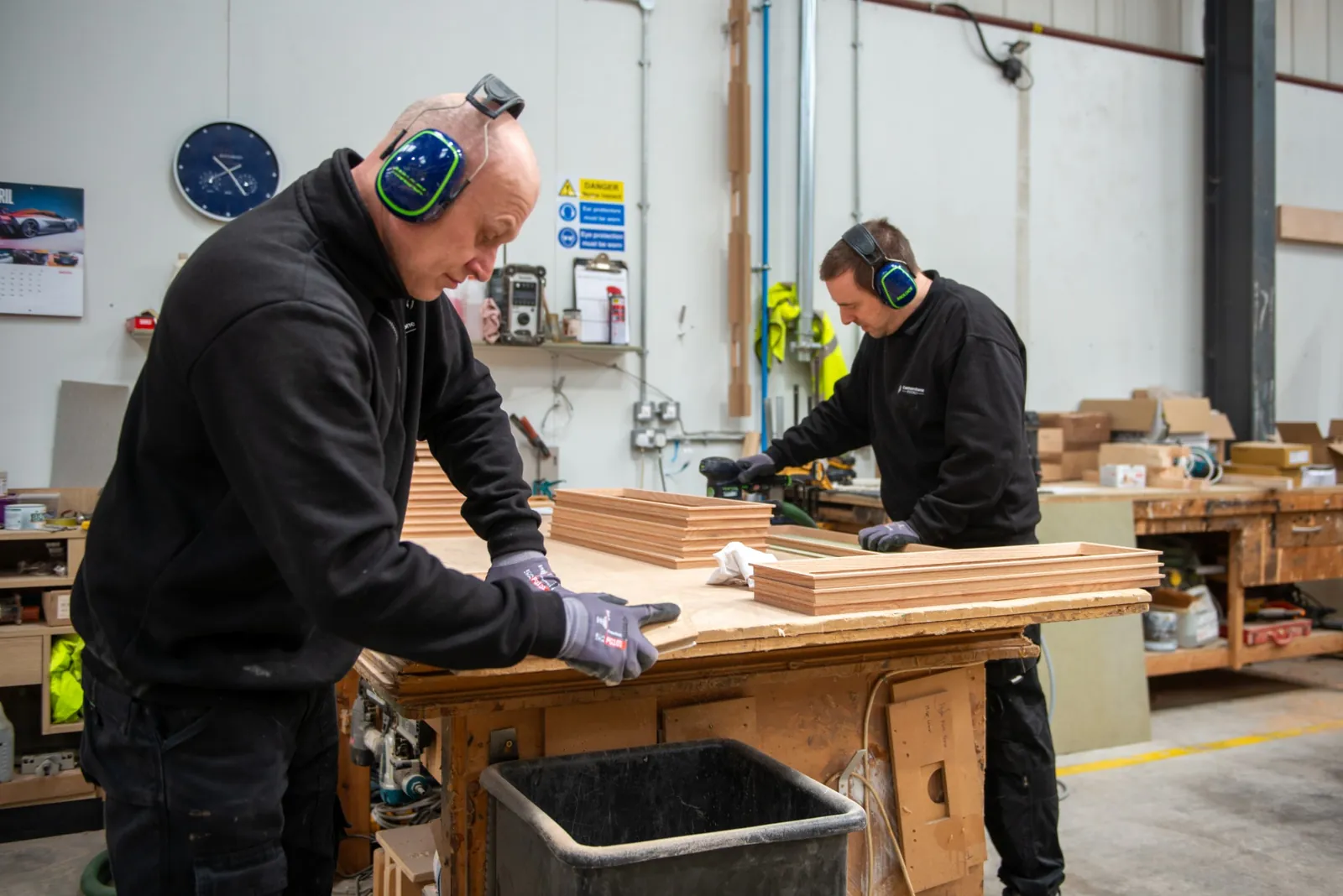 Sanding frames at the bench, ear defenders and gloves on