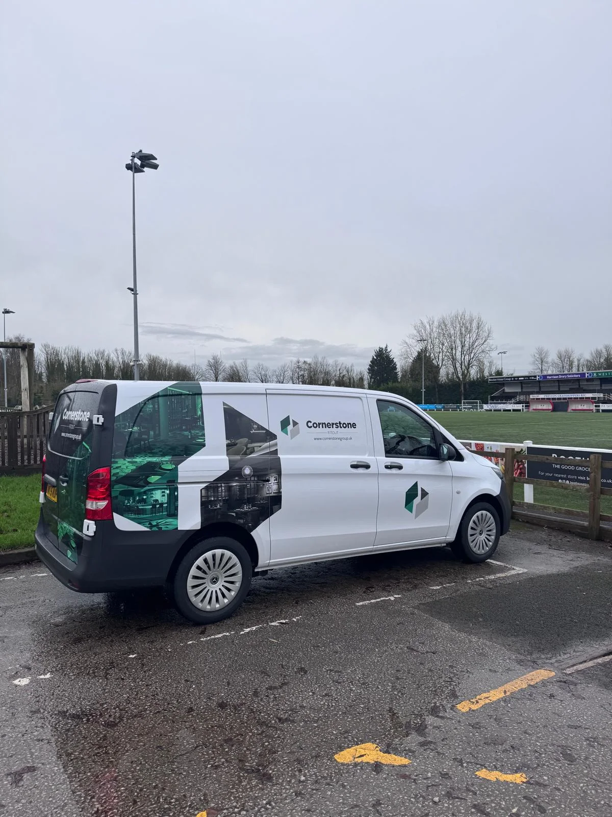 Cornerstone Fitout van parked beside the pitch at Preston Grasshoppers