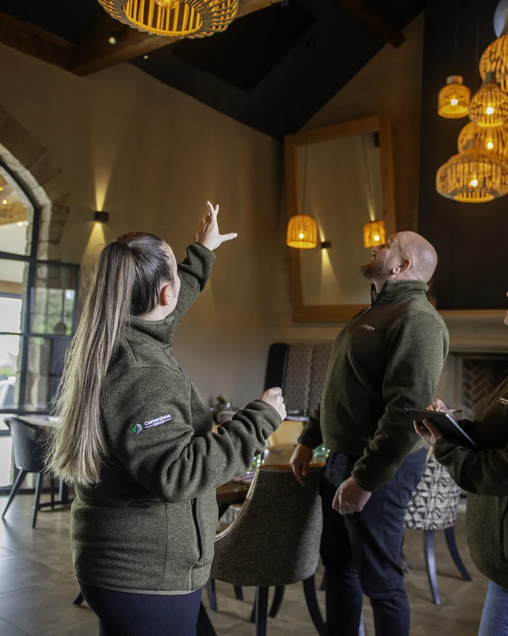 Cornerstone team walking through the restored dining room at Ye Horns Inn