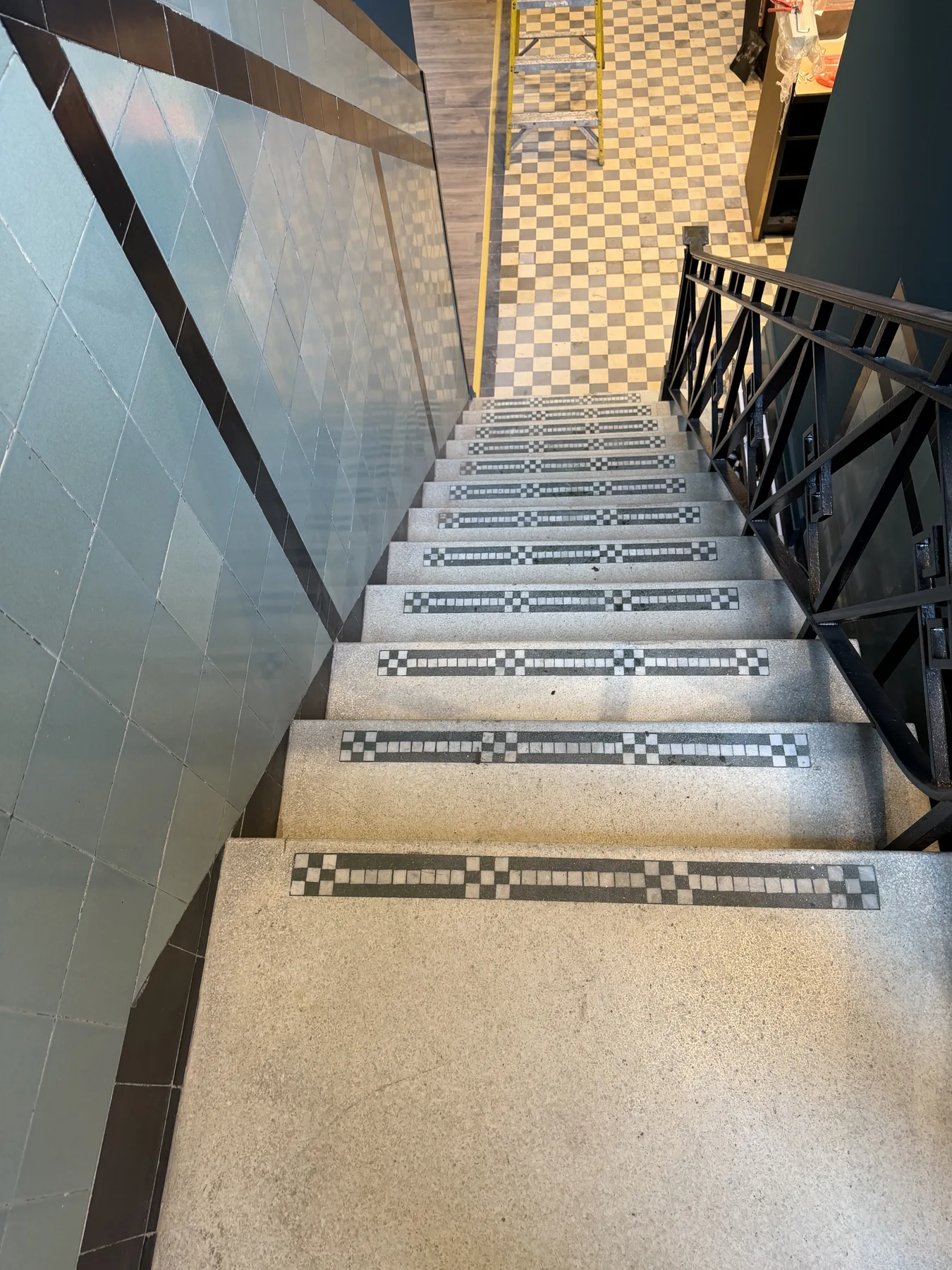 Terrazzo stair with mosaic nosings and glazed wall tiles