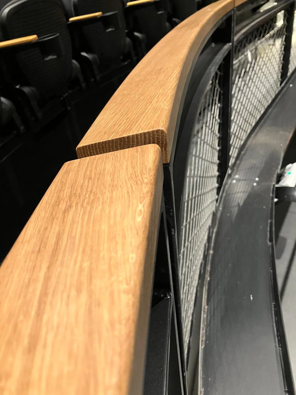 Curved solid oak handrail on the auditorium balcony front
