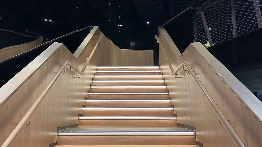 Oak-clad staircase with LED-lit nosings at Olympia London
