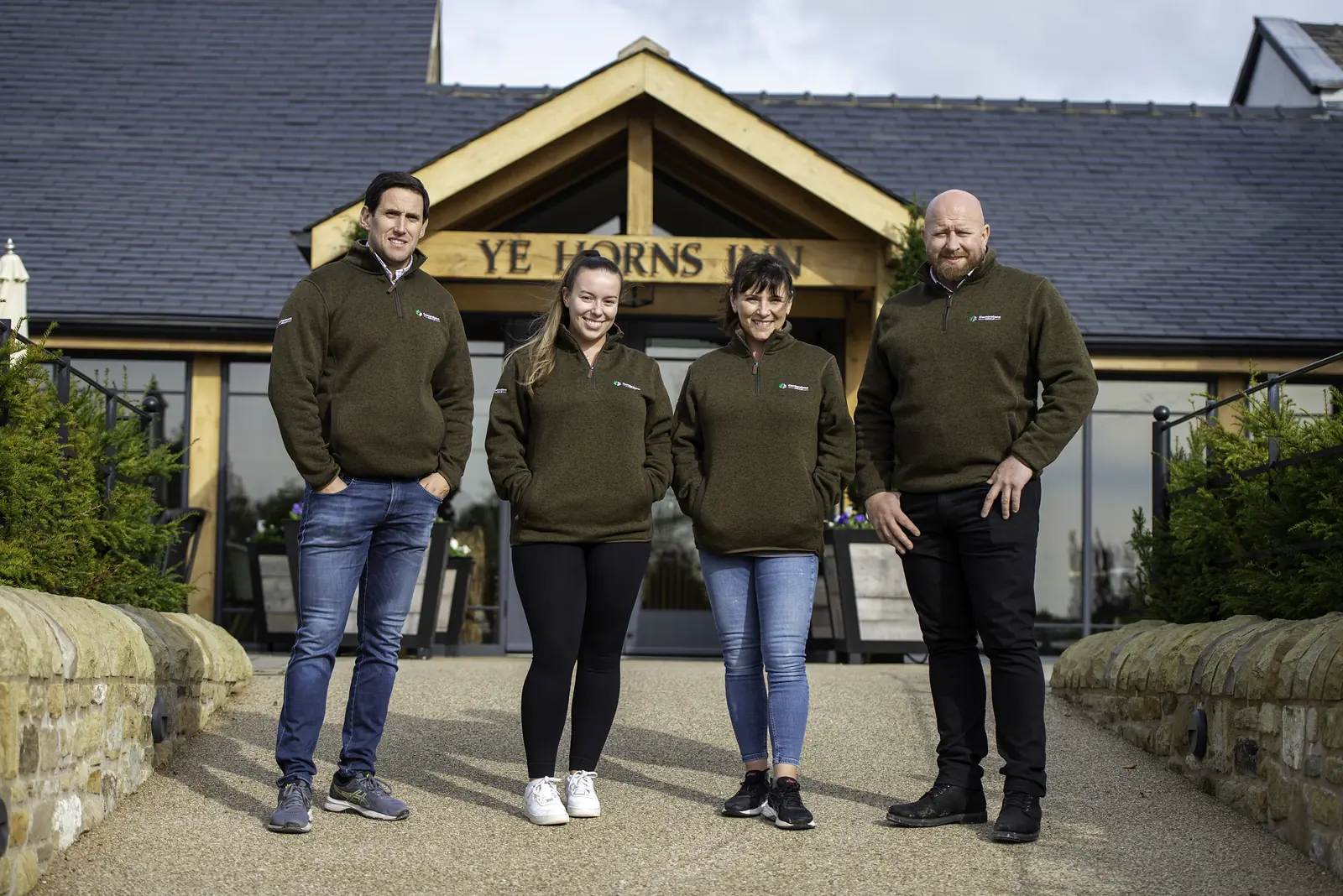 Cornerstone team at the entrance of the restored Ye Horns Inn