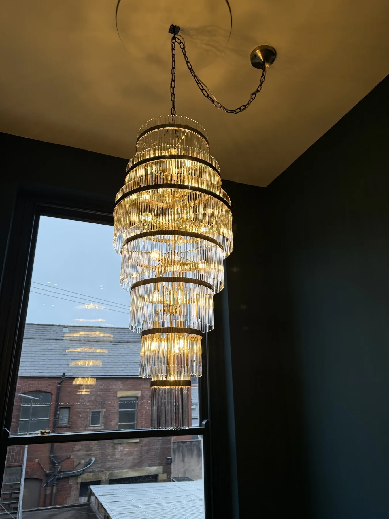 Tiered crystal chandelier in the stairwell window